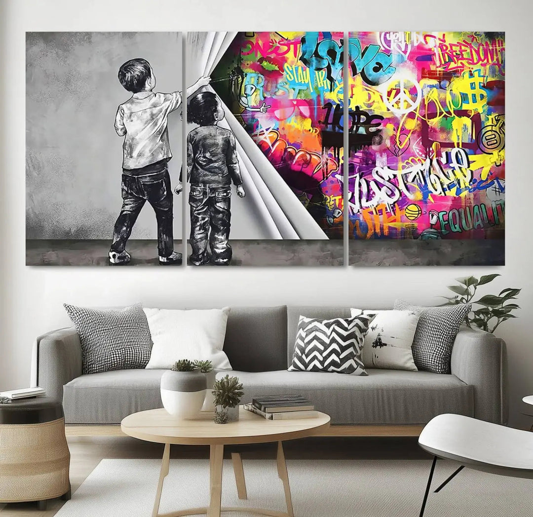 The Banksy Print - Street Art Canvas features a vibrant and bold image of two children lifting a curtain to reveal colorful graffiti. It's ready to hang, adding an urban modern decor vibe.