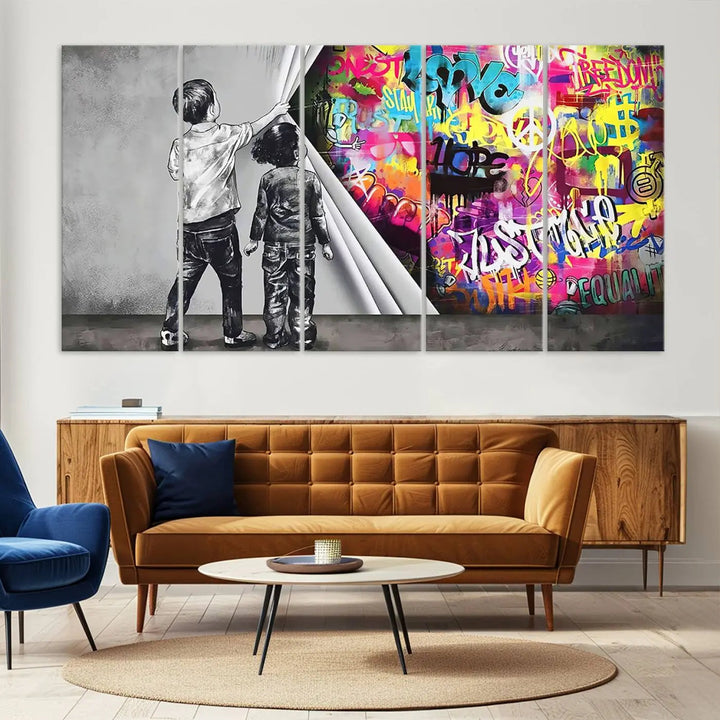 The Banksy Print - Street Art Canvas features a vibrant and bold image of two children lifting a curtain to reveal colorful graffiti. It's ready to hang, adding an urban modern decor vibe.