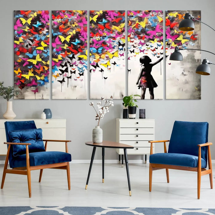 The Banksy Style Wall Art - Girl and Butterfly Explosion features a silhouette of a girl reaching for colorful butterflies on a three-panel canvas print.