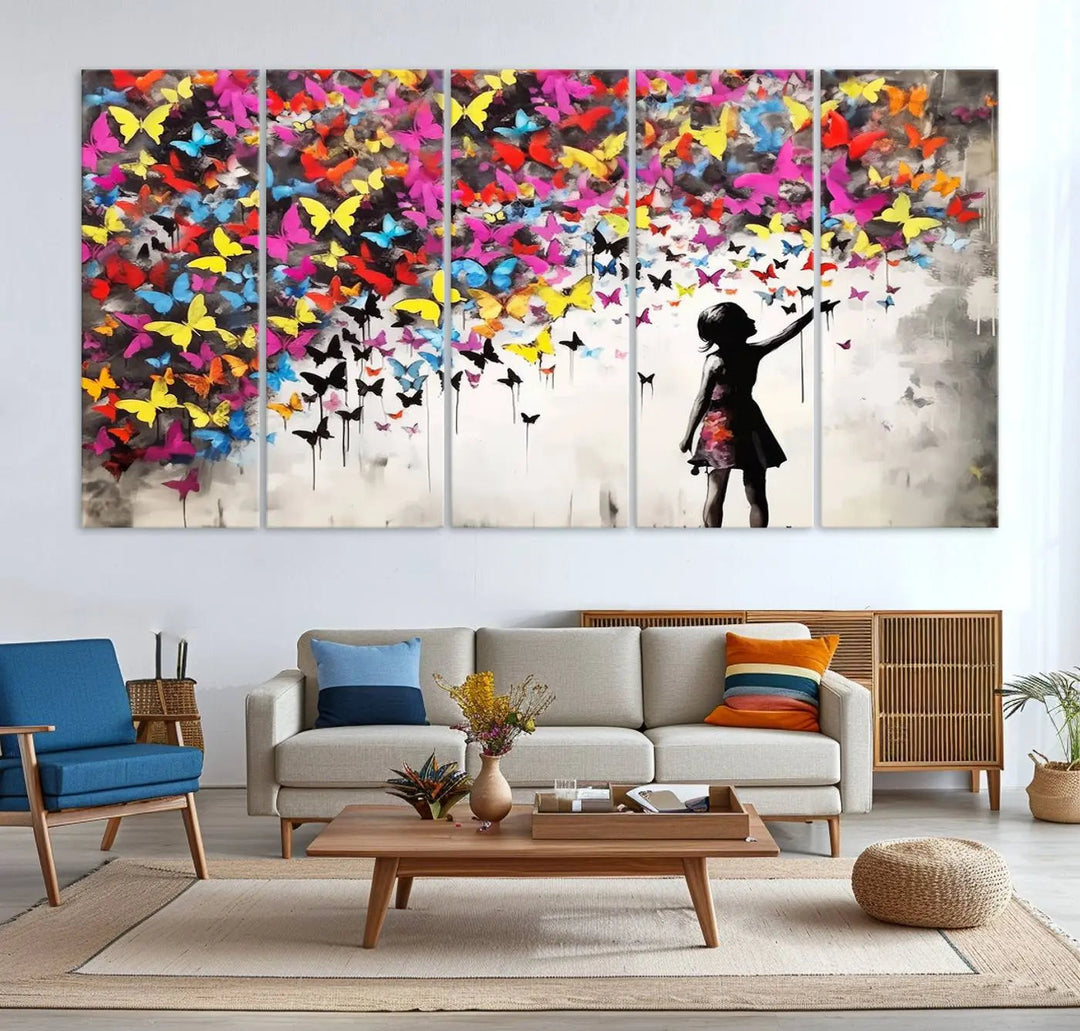 The Banksy Style Wall Art - Girl and Butterfly Explosion features a silhouette of a girl reaching for colorful butterflies on a three-panel canvas print.