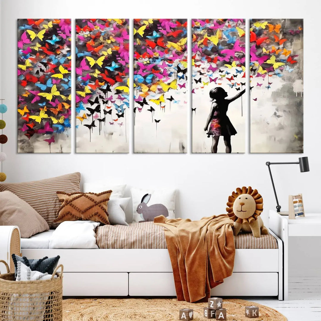 The Banksy Style Wall Art - Girl and Butterfly Explosion features a silhouette of a girl reaching for colorful butterflies on a three-panel canvas print.