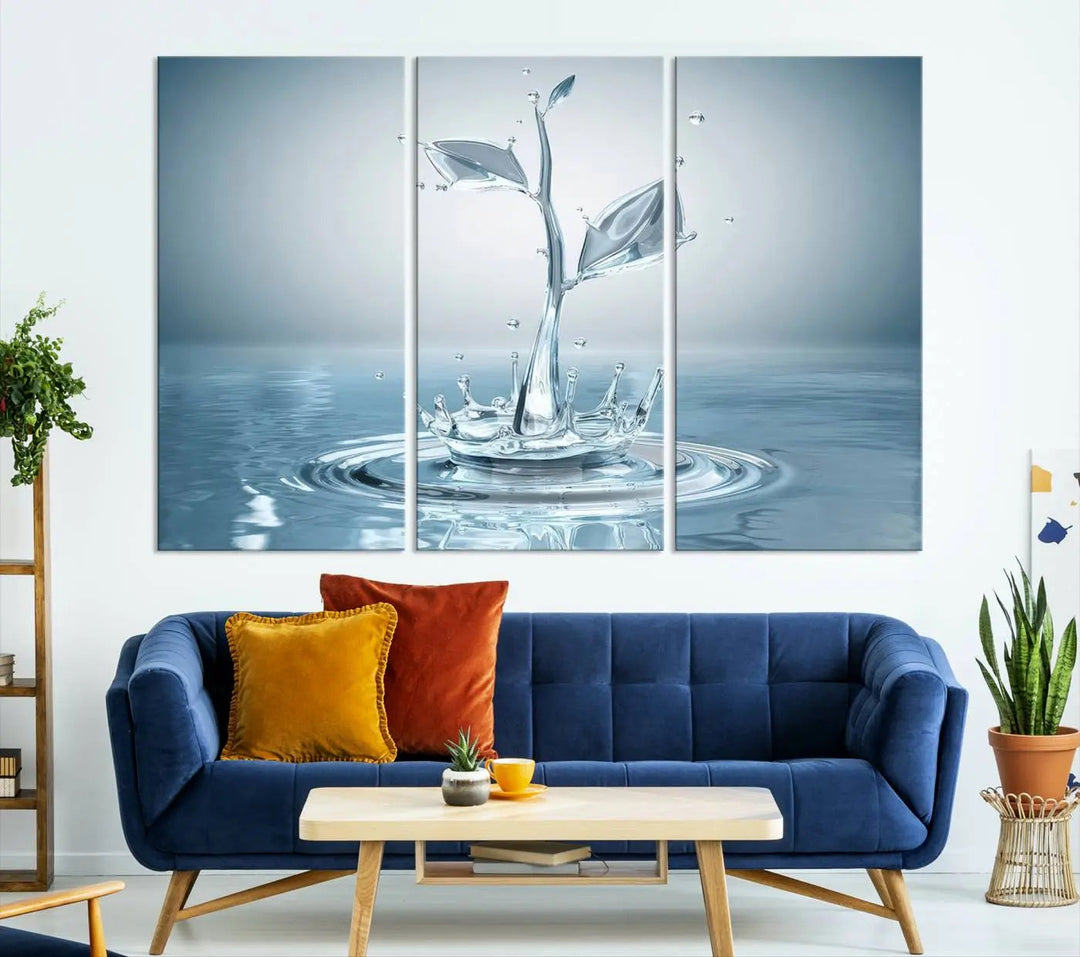 The living room features a three-panel wall art titled "Bathroom Wall Art Blue Leaf Canvas," showcasing water splash shapes that form plant-like designs on gallery-wrapped, museum-quality canvas.