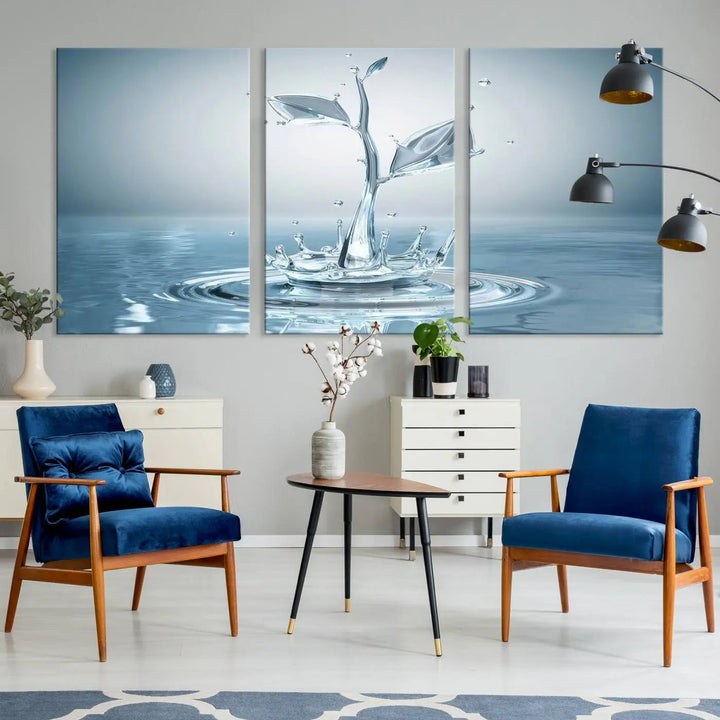 The living room features a three-panel wall art titled "Bathroom Wall Art Blue Leaf Canvas," showcasing water splash shapes that form plant-like designs on gallery-wrapped, museum-quality canvas.