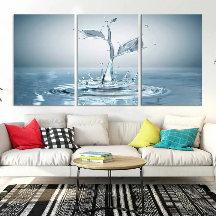 The living room features a three-panel wall art titled "Bathroom Wall Art Blue Leaf Canvas," showcasing water splash shapes that form plant-like designs on gallery-wrapped, museum-quality canvas.