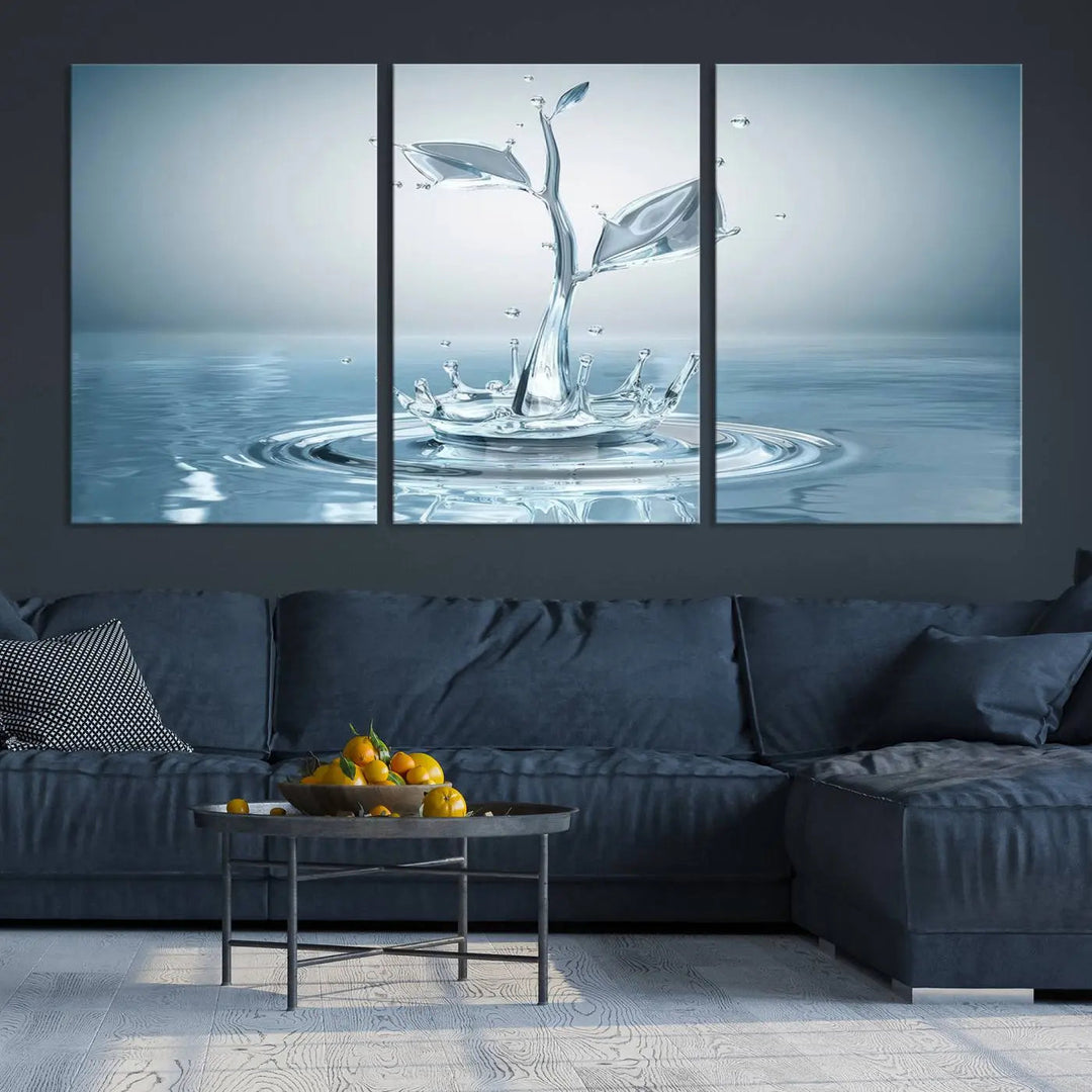 The living room features a three-panel wall art titled "Bathroom Wall Art Blue Leaf Canvas," showcasing water splash shapes that form plant-like designs on gallery-wrapped, museum-quality canvas.