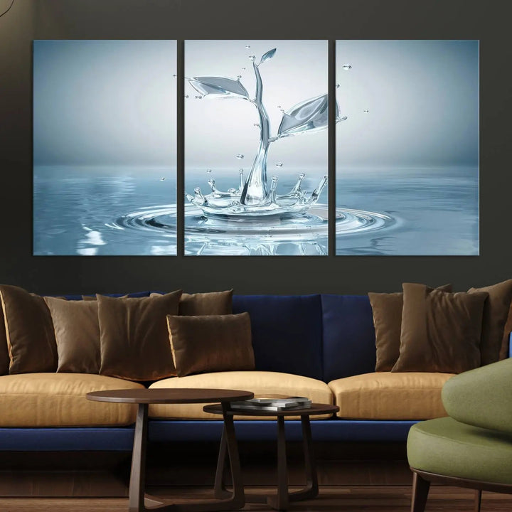 The living room features a three-panel wall art titled "Bathroom Wall Art Blue Leaf Canvas," showcasing water splash shapes that form plant-like designs on gallery-wrapped, museum-quality canvas.