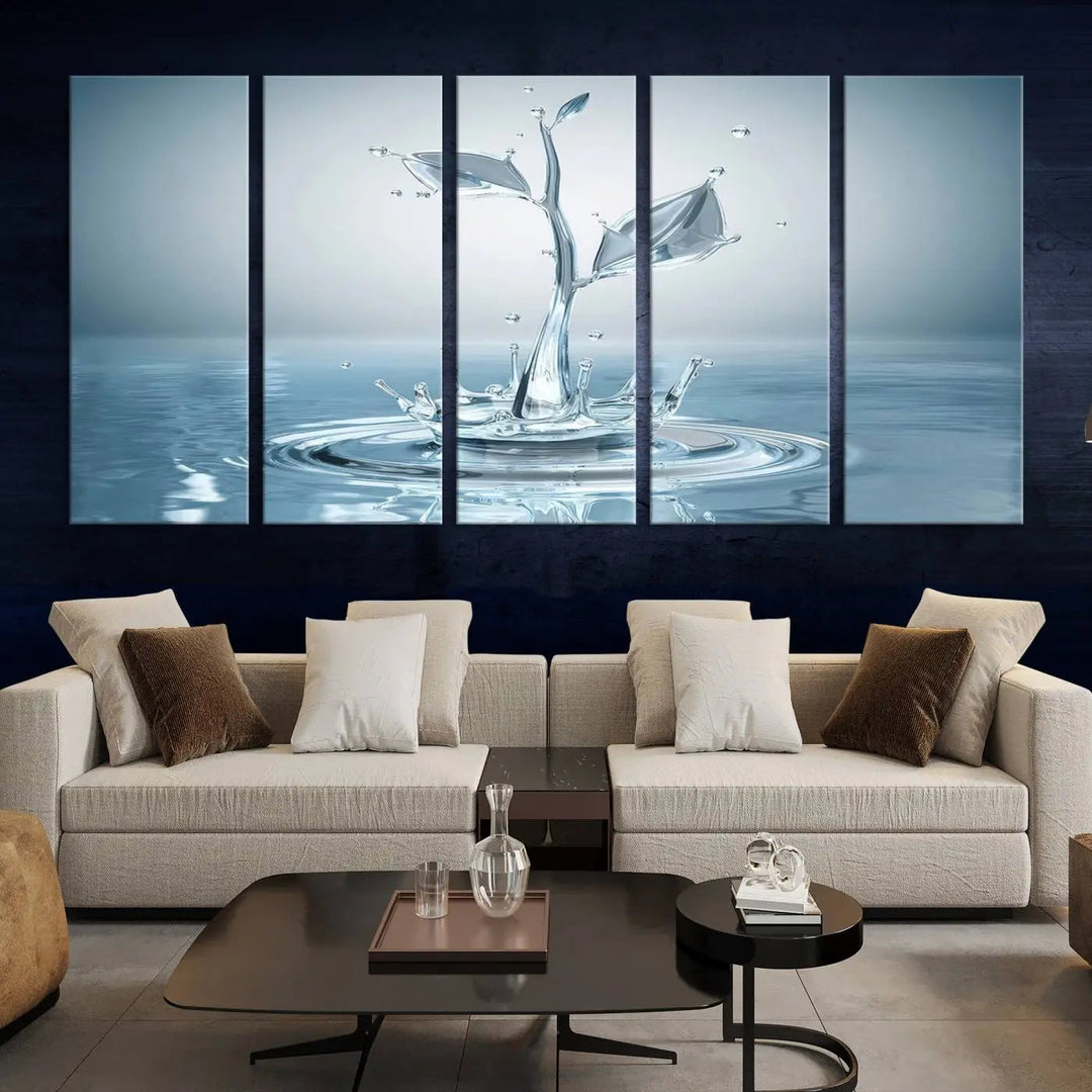 The living room features a three-panel wall art titled "Bathroom Wall Art Blue Leaf Canvas," showcasing water splash shapes that form plant-like designs on gallery-wrapped, museum-quality canvas.