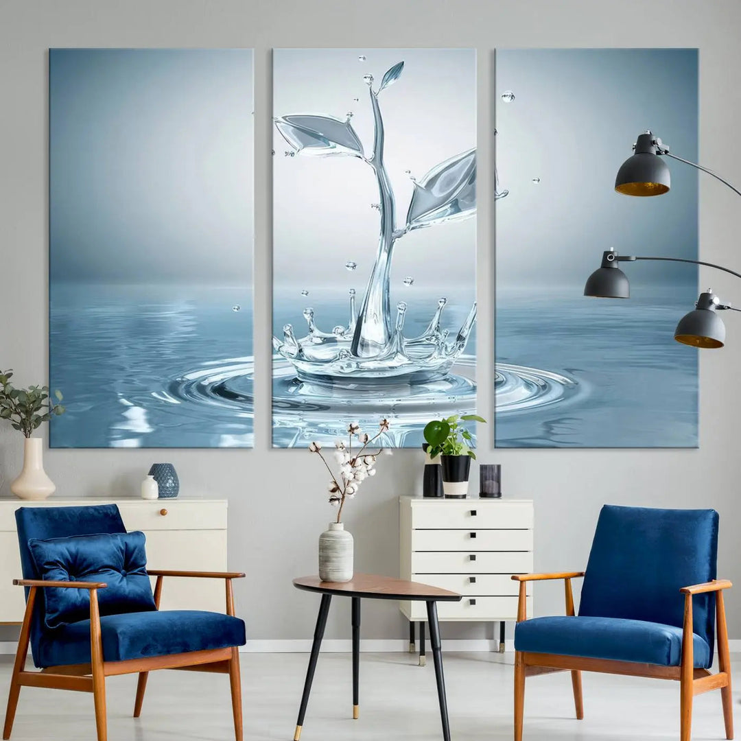 The living room features a three-panel wall art titled "Bathroom Wall Art Blue Leaf Canvas," showcasing water splash shapes that form plant-like designs on gallery-wrapped, museum-quality canvas.