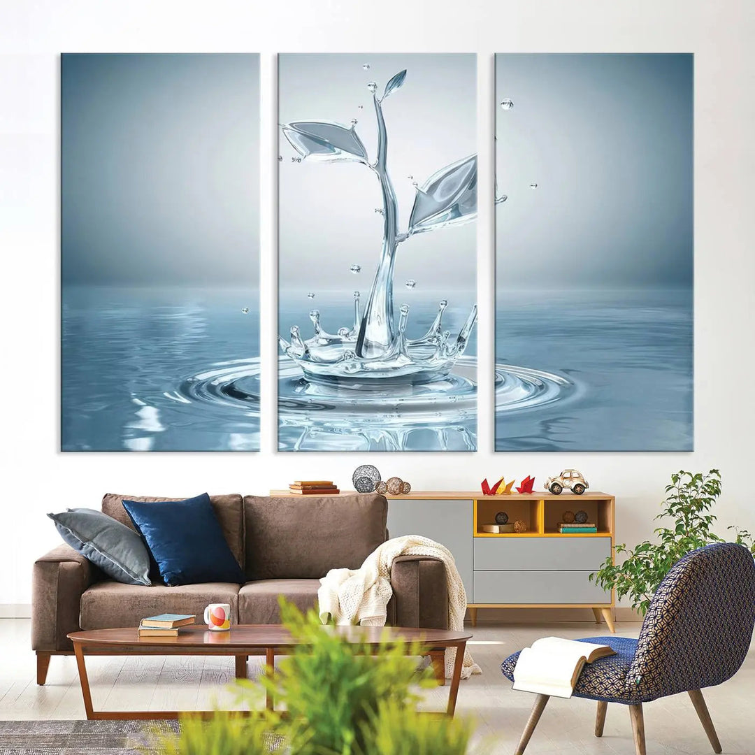 The living room features a three-panel wall art titled "Bathroom Wall Art Blue Leaf Canvas," showcasing water splash shapes that form plant-like designs on gallery-wrapped, museum-quality canvas.