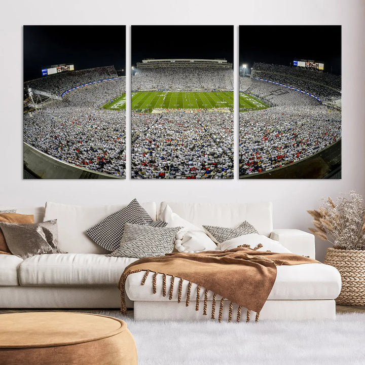 The Beaver Stadium Night Game Triple Canvas Wall Art - Penn State Nittany Lions Football Match features a panoramic view of a packed Beaver Stadium at night.