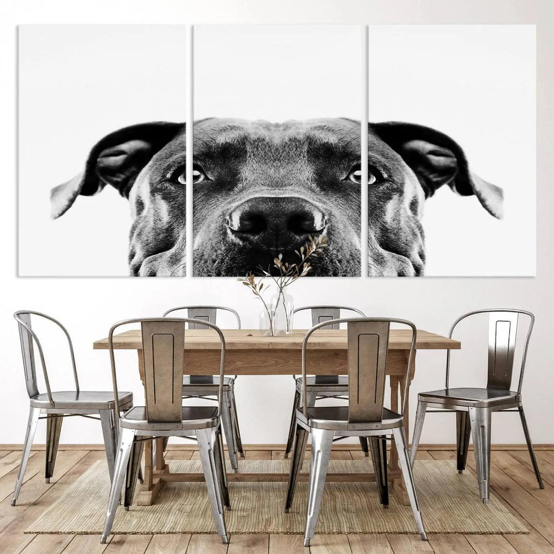 The "Black and White Pit Bull Dog Wall Art Canvas Print" elegantly adorns the living room, infusing character and charm into the contemporary setting. This captivating piece is perfect for dog lovers.