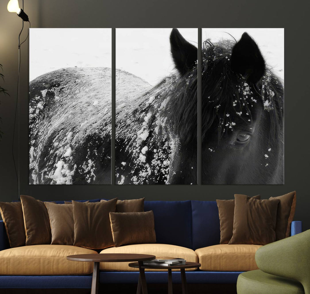 The "Black Horse in Snow Canvas Print" serves as an ideal rustic cabin wall art centerpiece with its triptych design of a snowy black horse.