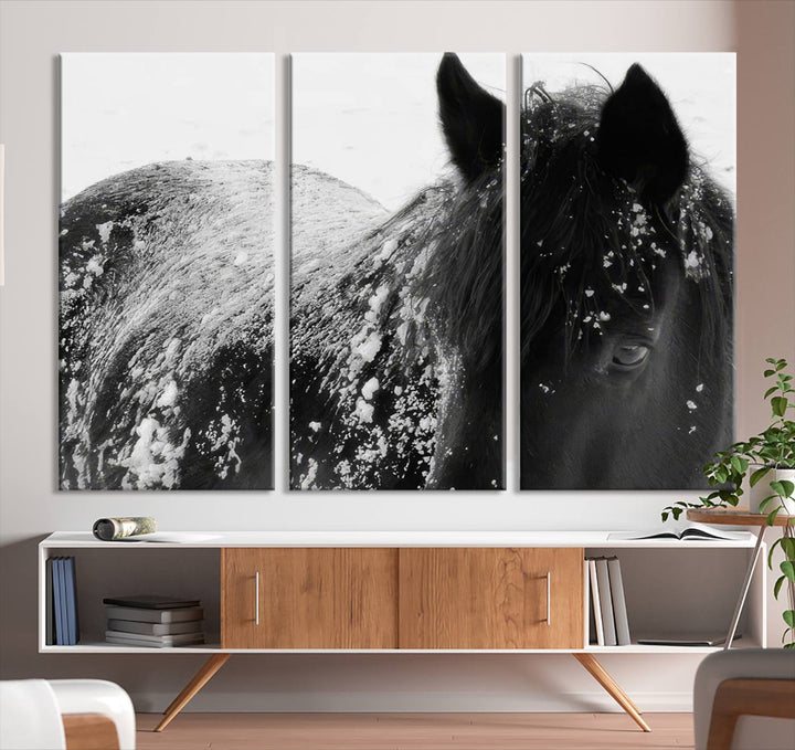 The "Black Horse in Snow Canvas Print" serves as an ideal rustic cabin wall art centerpiece with its triptych design of a snowy black horse.