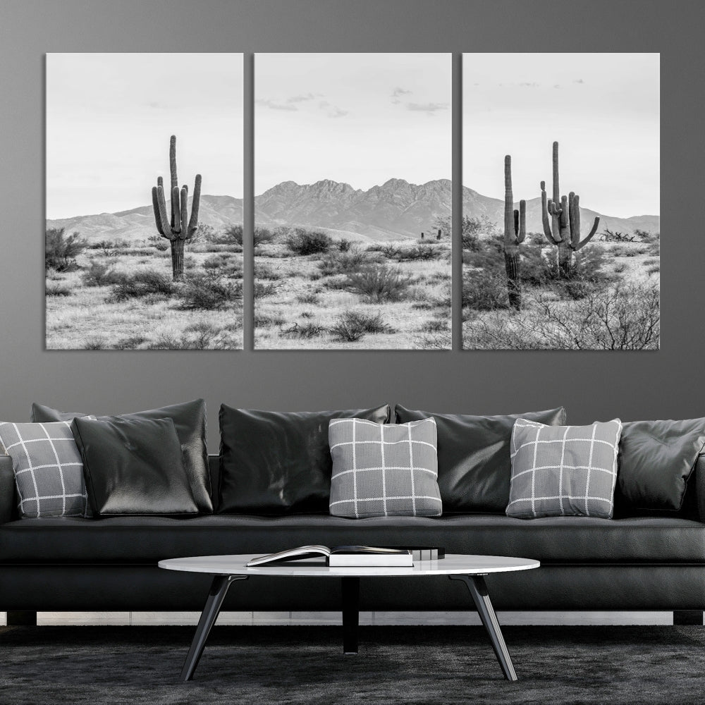 The modern living room showcases the "Black White Arizona Desert Canvas Wall Art Cactus Farmhouse Wall Art," a triptych consisting of gallery-wrapped, museum-quality black-and-white desert landscape photographs featuring cacti.