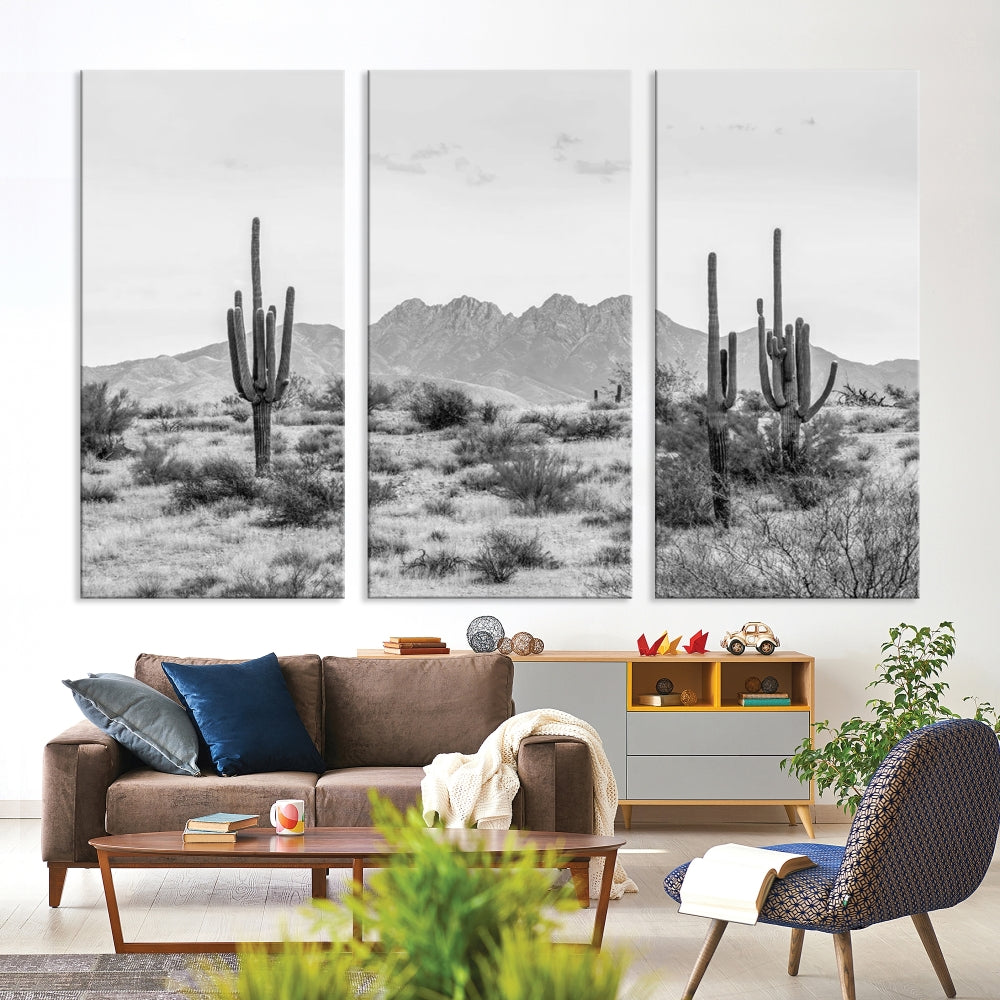 The modern living room showcases the "Black White Arizona Desert Canvas Wall Art Cactus Farmhouse Wall Art," a triptych consisting of gallery-wrapped, museum-quality black-and-white desert landscape photographs featuring cacti.