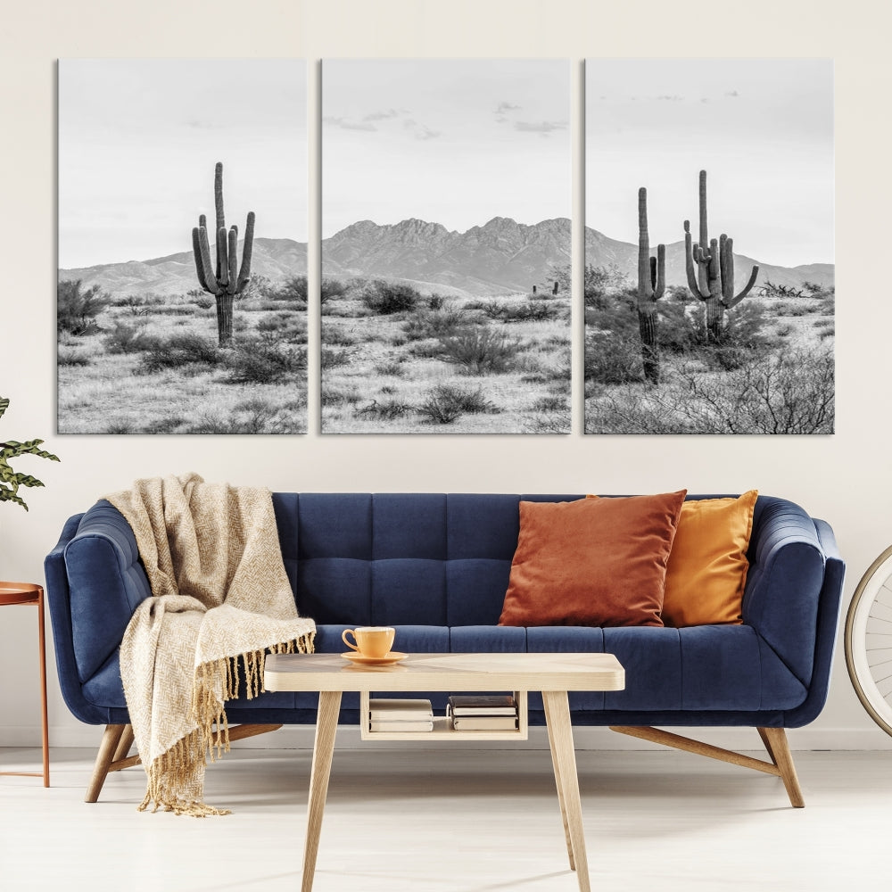 The modern living room showcases the "Black White Arizona Desert Canvas Wall Art Cactus Farmhouse Wall Art," a triptych consisting of gallery-wrapped, museum-quality black-and-white desert landscape photographs featuring cacti.