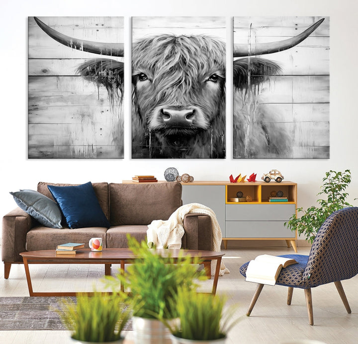 The Black White Highland Cow Wall Art Canvas Print, crafted on museum-quality canvases with a UV-protective coating, adds an elegant touch to the rustic wooden backdrop.