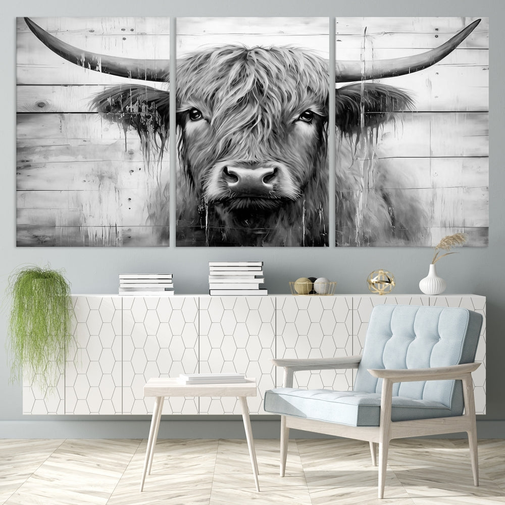 The Black White Highland Cow Wall Art Canvas Print, crafted on museum-quality canvases with a UV-protective coating, adds an elegant touch to the rustic wooden backdrop.