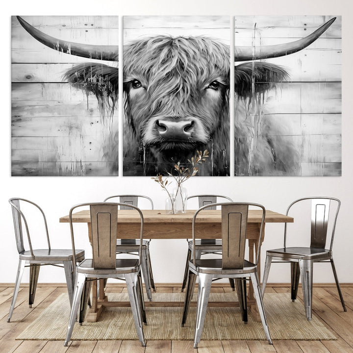 The Black White Highland Cow Wall Art Canvas Print, crafted on museum-quality canvases with a UV-protective coating, adds an elegant touch to the rustic wooden backdrop.