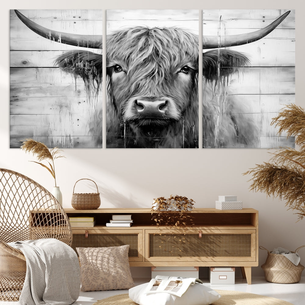 The Black White Highland Cow Wall Art Canvas Print, crafted on museum-quality canvases with a UV-protective coating, adds an elegant touch to the rustic wooden backdrop.