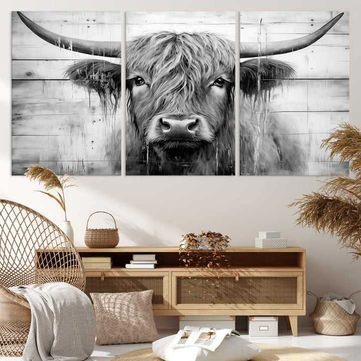 The Black White Highland Cow Wall Art Canvas Print, crafted on museum-quality canvases with a UV-protective coating, adds an elegant touch to the rustic wooden backdrop.