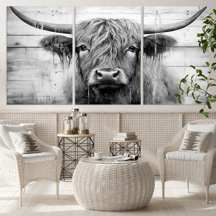 The Black White Highland Cow Wall Art Canvas Print, crafted on museum-quality canvases with a UV-protective coating, adds an elegant touch to the rustic wooden backdrop.