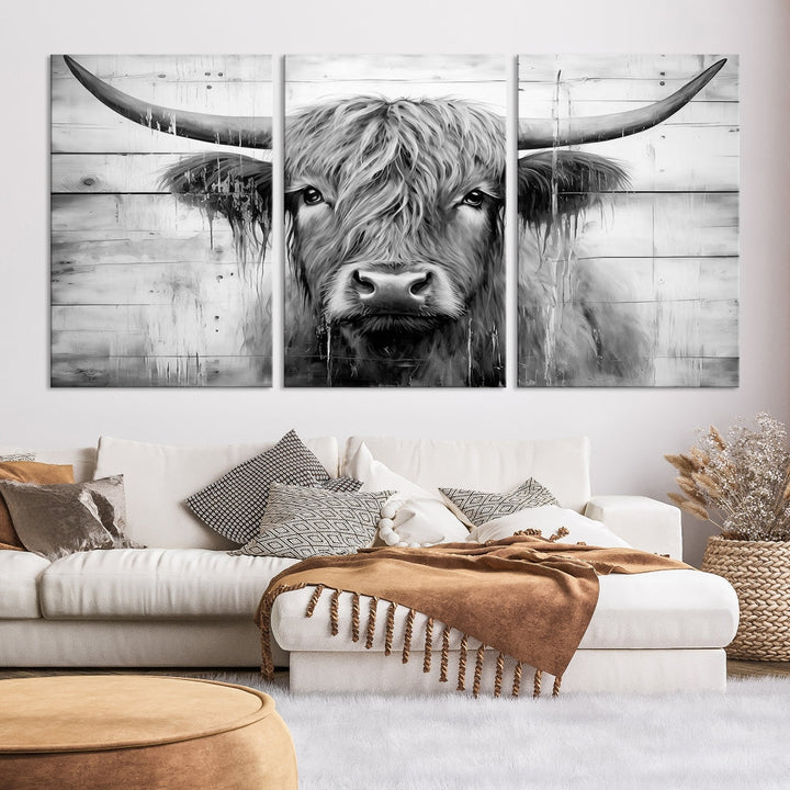 The Black White Highland Cow Wall Art Canvas Print, crafted on museum-quality canvases with a UV-protective coating, adds an elegant touch to the rustic wooden backdrop.