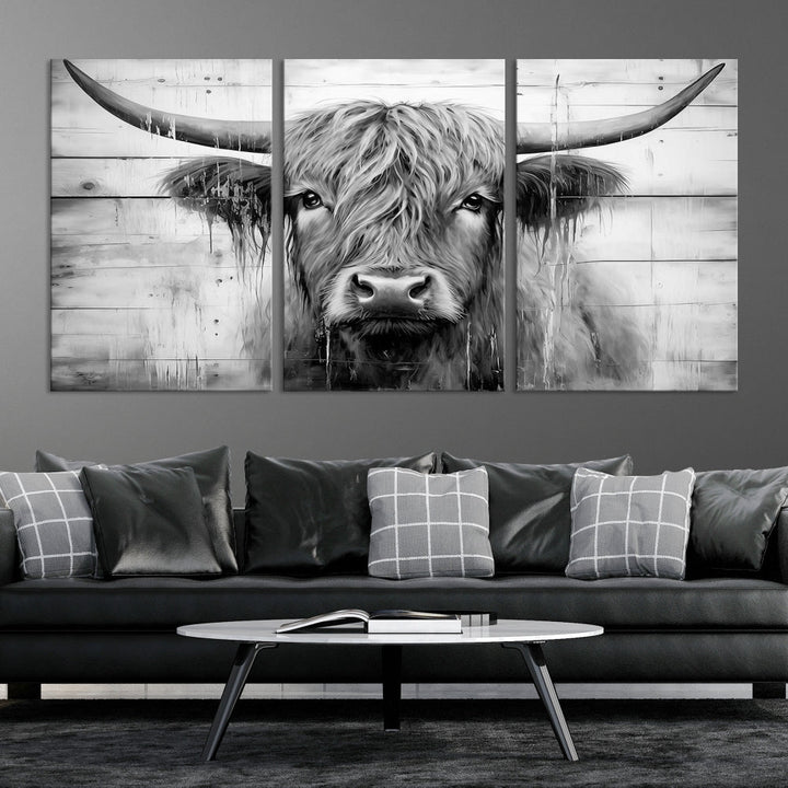 The Black White Highland Cow Wall Art Canvas Print, crafted on museum-quality canvases with a UV-protective coating, adds an elegant touch to the rustic wooden backdrop.