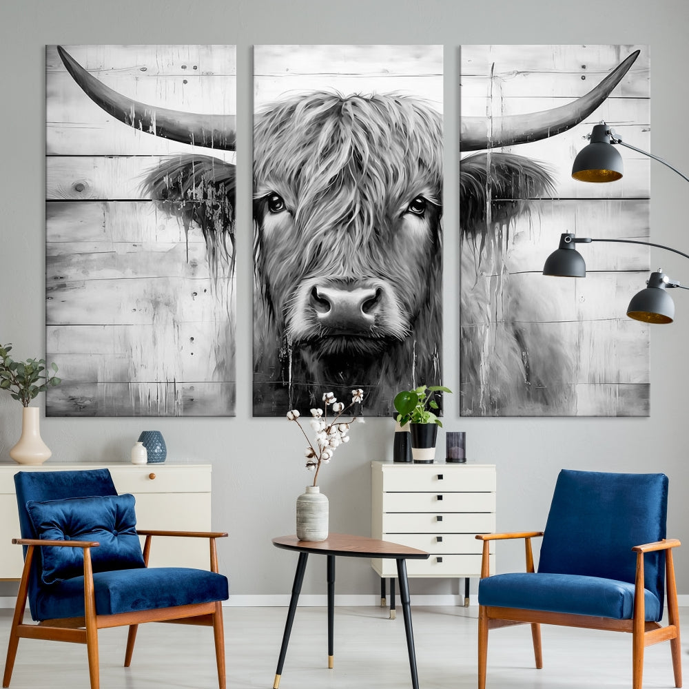 The Black White Highland Cow Wall Art Canvas Print, crafted on museum-quality canvases with a UV-protective coating, adds an elegant touch to the rustic wooden backdrop.