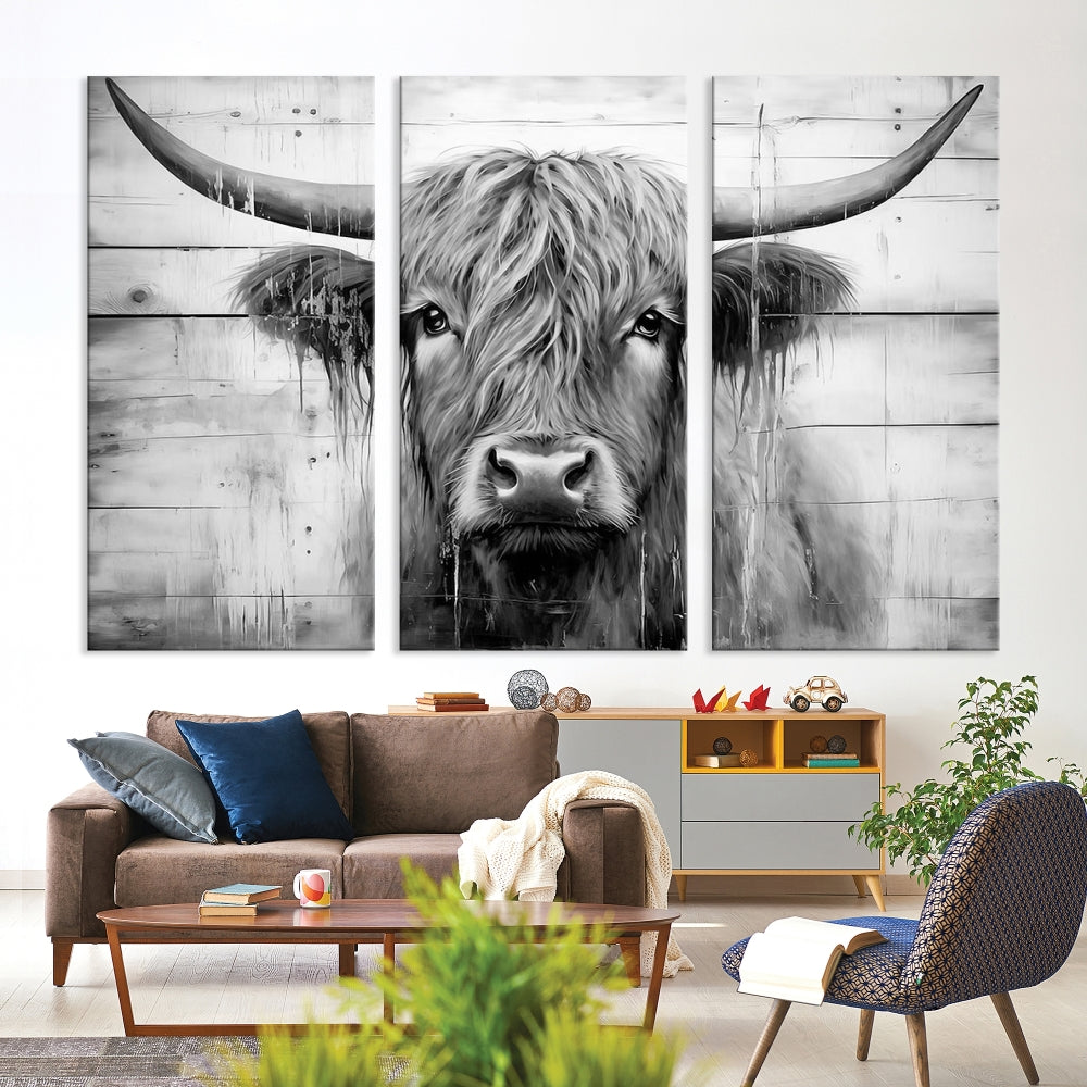 The Black White Highland Cow Wall Art Canvas Print, crafted on museum-quality canvases with a UV-protective coating, adds an elegant touch to the rustic wooden backdrop.