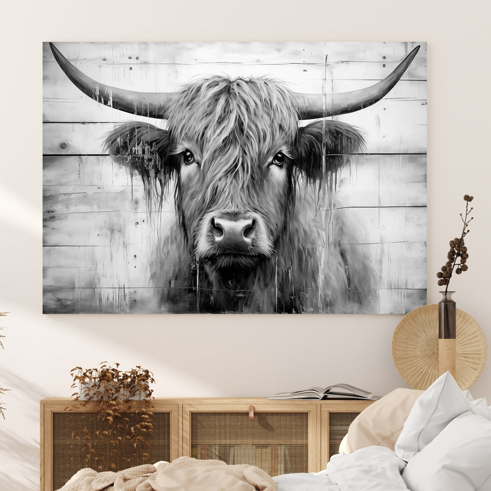 The Black White Highland Cow Wall Art Canvas Print, crafted on museum-quality canvases with a UV-protective coating, adds an elegant touch to the rustic wooden backdrop.