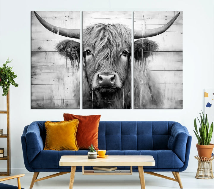 The Black White Highland Cow Wall Art Canvas Print, crafted on museum-quality canvases with a UV-protective coating, adds an elegant touch to the rustic wooden backdrop.