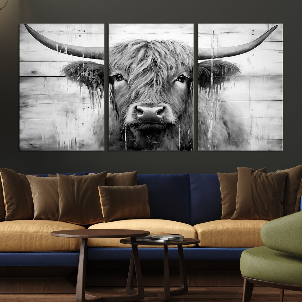 The Black White Highland Cow Wall Art Canvas Print, crafted on museum-quality canvases with a UV-protective coating, adds an elegant touch to the rustic wooden backdrop.