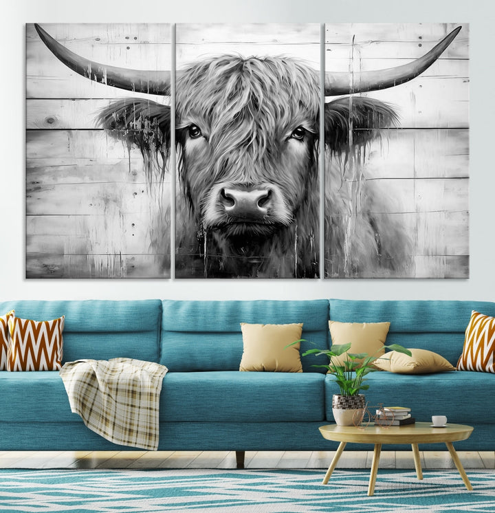 The Black White Highland Cow Wall Art Canvas Print, crafted on museum-quality canvases with a UV-protective coating, adds an elegant touch to the rustic wooden backdrop.