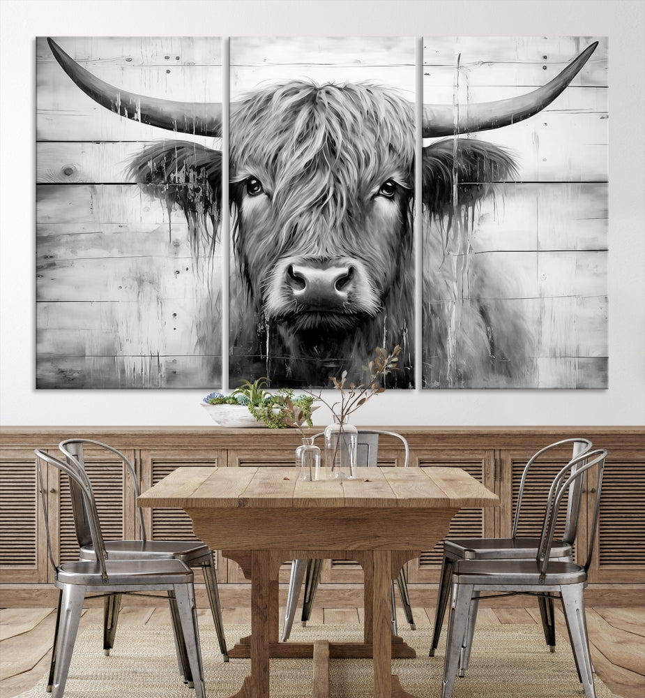 The Black White Highland Cow Wall Art Canvas Print, crafted on museum-quality canvases with a UV-protective coating, adds an elegant touch to the rustic wooden backdrop.