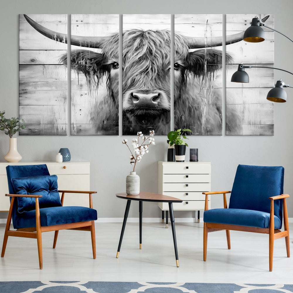 The Black White Highland Cow Wall Art Canvas Print, crafted on museum-quality canvases with a UV-protective coating, adds an elegant touch to the rustic wooden backdrop.