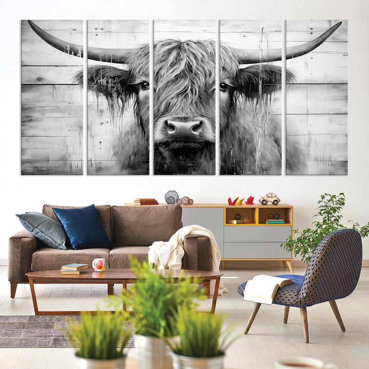 The Black White Highland Cow Wall Art Canvas Print, crafted on museum-quality canvases with a UV-protective coating, adds an elegant touch to the rustic wooden backdrop.