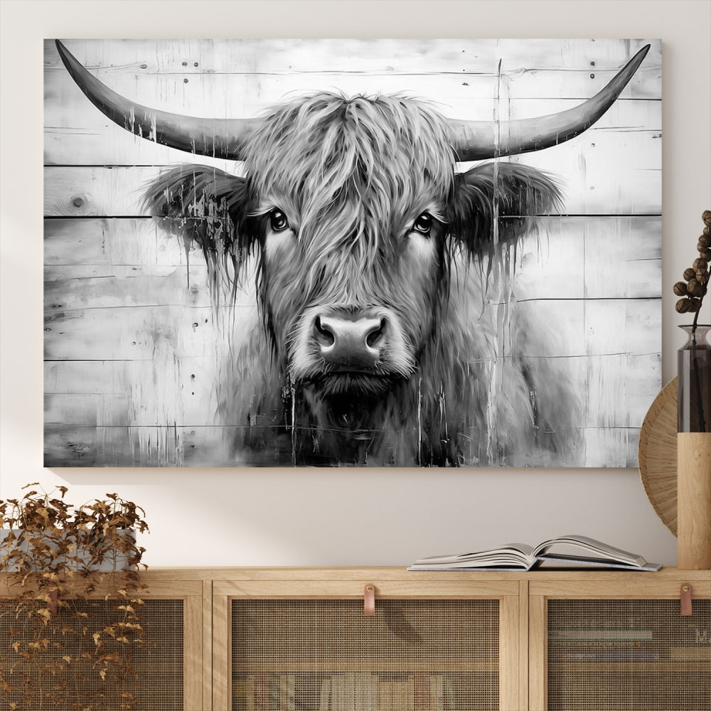 The Black White Highland Cow Wall Art Canvas Print, crafted on museum-quality canvases with a UV-protective coating, adds an elegant touch to the rustic wooden backdrop.