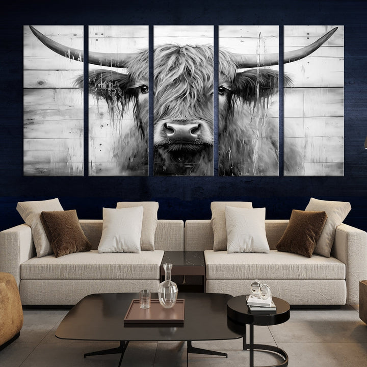 The Black White Highland Cow Wall Art Canvas Print, crafted on museum-quality canvases with a UV-protective coating, adds an elegant touch to the rustic wooden backdrop.