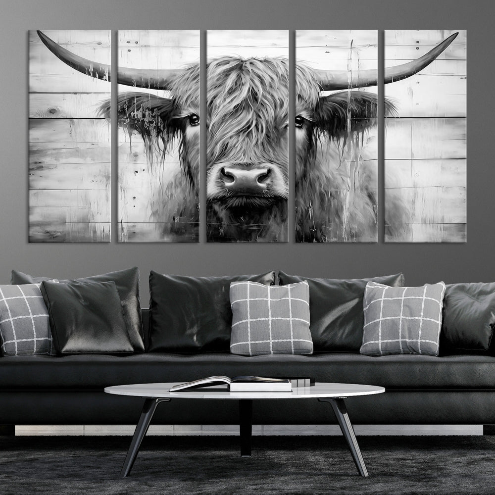 The Black White Highland Cow Wall Art Canvas Print, crafted on museum-quality canvases with a UV-protective coating, adds an elegant touch to the rustic wooden backdrop.