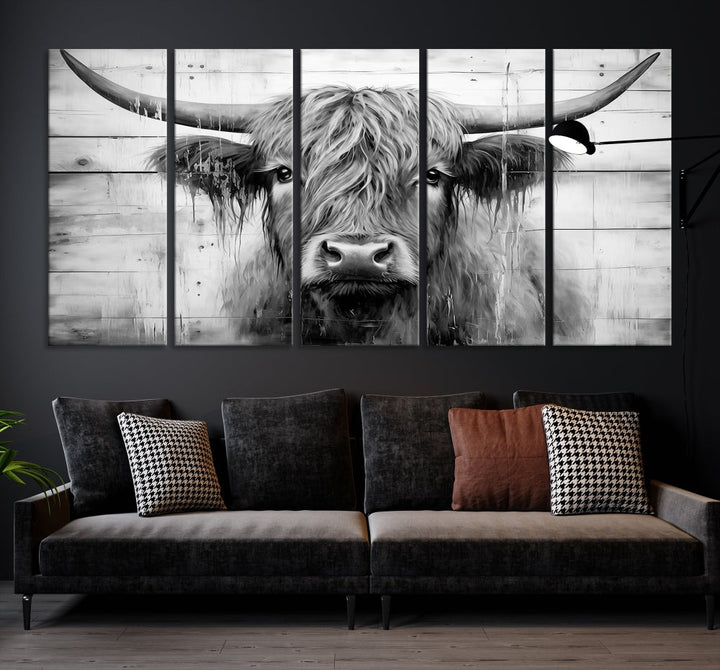 The Black White Highland Cow Wall Art Canvas Print, crafted on museum-quality canvases with a UV-protective coating, adds an elegant touch to the rustic wooden backdrop.