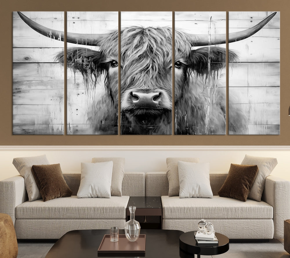 The Black White Highland Cow Wall Art Canvas Print, crafted on museum-quality canvases with a UV-protective coating, adds an elegant touch to the rustic wooden backdrop.