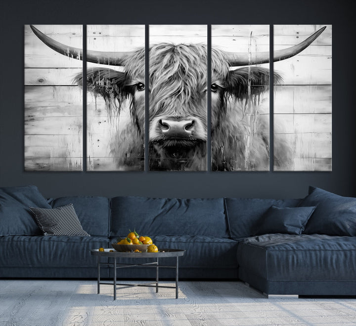 The Black White Highland Cow Wall Art Canvas Print, crafted on museum-quality canvases with a UV-protective coating, adds an elegant touch to the rustic wooden backdrop.