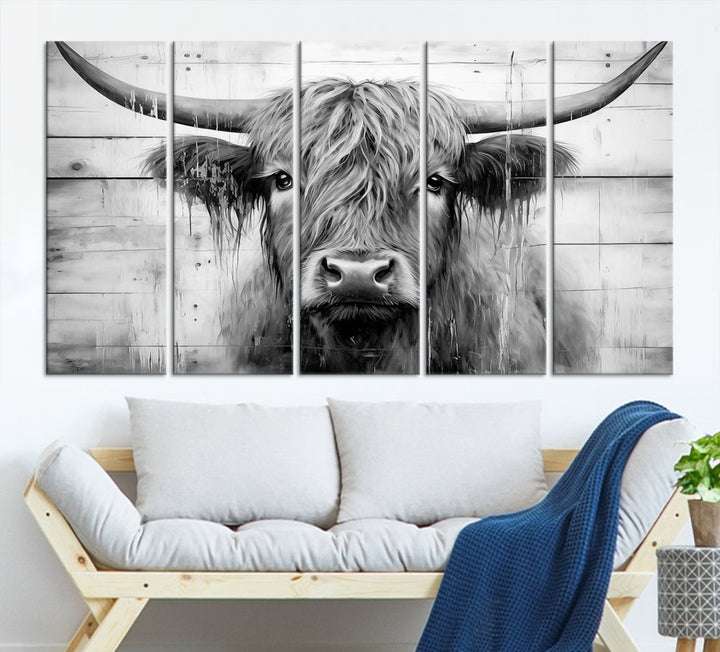 The Black White Highland Cow Wall Art Canvas Print, crafted on museum-quality canvases with a UV-protective coating, adds an elegant touch to the rustic wooden backdrop.