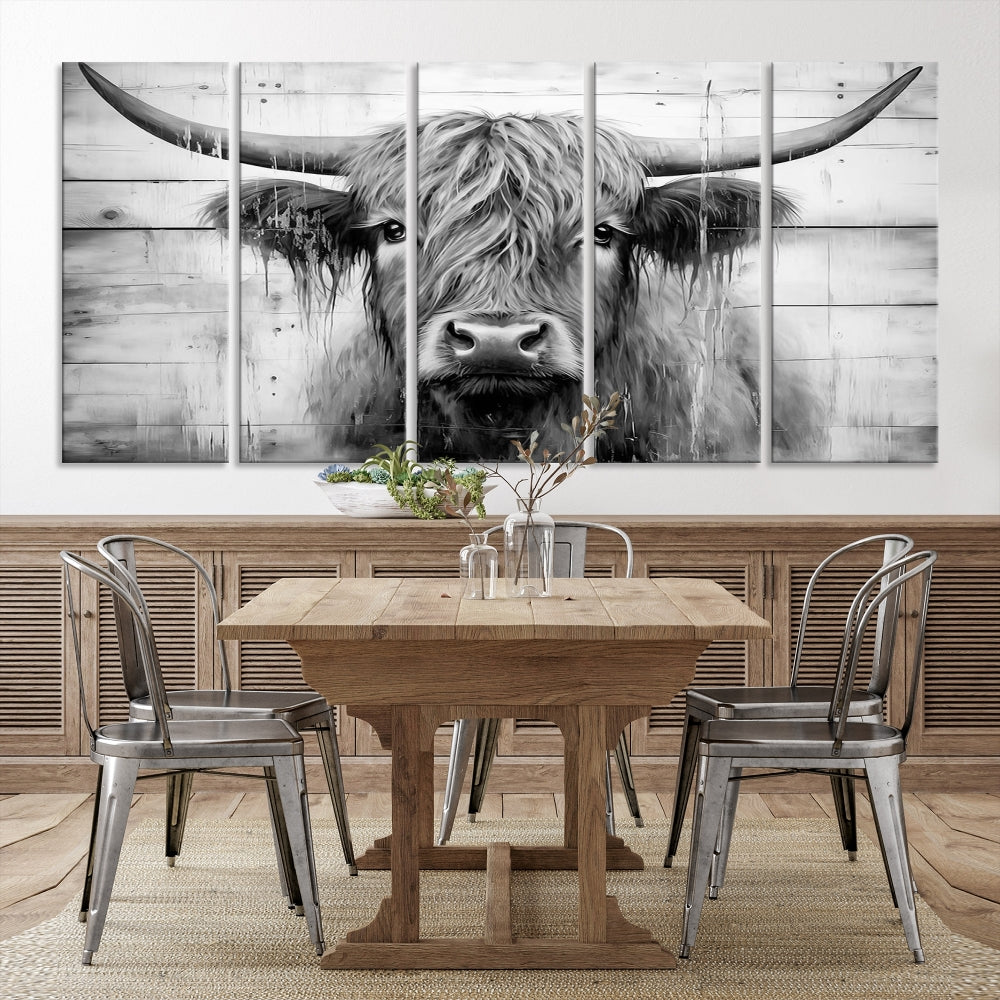 The Black White Highland Cow Wall Art Canvas Print, crafted on museum-quality canvases with a UV-protective coating, adds an elegant touch to the rustic wooden backdrop.