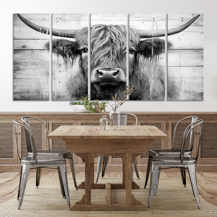 The Black White Highland Cow Wall Art Canvas Print, crafted on museum-quality canvases with a UV-protective coating, adds an elegant touch to the rustic wooden backdrop.