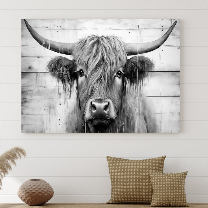 The Black White Highland Cow Wall Art Canvas Print, crafted on museum-quality canvases with a UV-protective coating, adds an elegant touch to the rustic wooden backdrop.