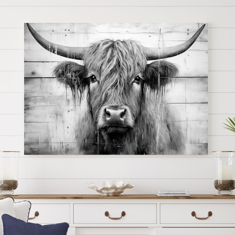 The Black White Highland Cow Wall Art Canvas Print, crafted on museum-quality canvases with a UV-protective coating, adds an elegant touch to the rustic wooden backdrop.