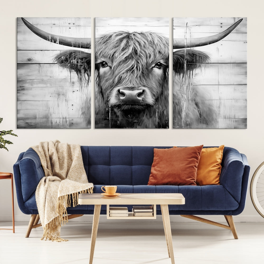 The Black White Highland Cow Wall Art Canvas Print, crafted on museum-quality canvases with a UV-protective coating, adds an elegant touch to the rustic wooden backdrop.