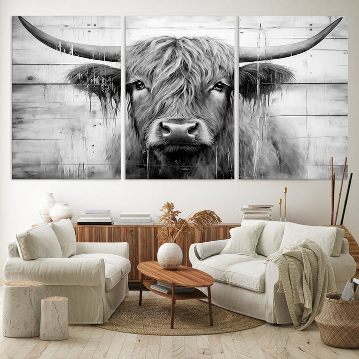 The Black White Highland Cow Wall Art Canvas Print, crafted on museum-quality canvases with a UV-protective coating, adds an elegant touch to the rustic wooden backdrop.